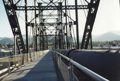 Bike path along with a pipe across the river